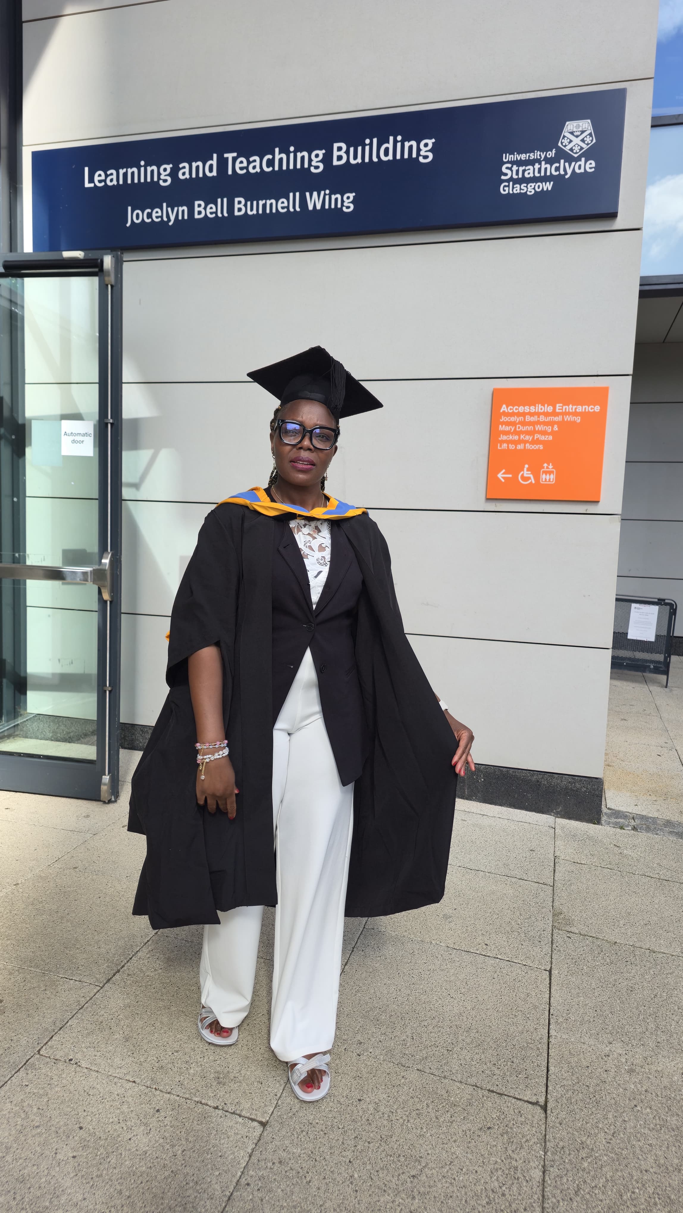 Catherine Cherotich outside the Learning and Teaching Building at the University of Strathclyde on her graduation day