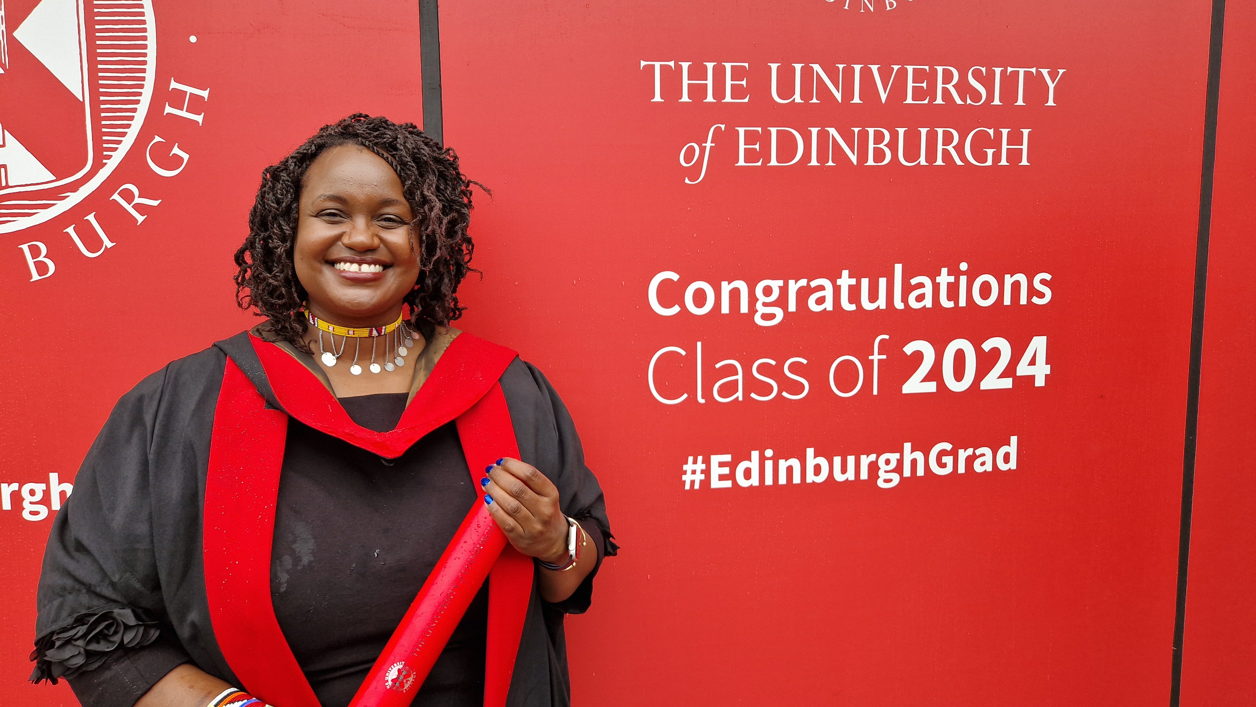 Close-up of Bridgit holding her scroll, smiling confidently