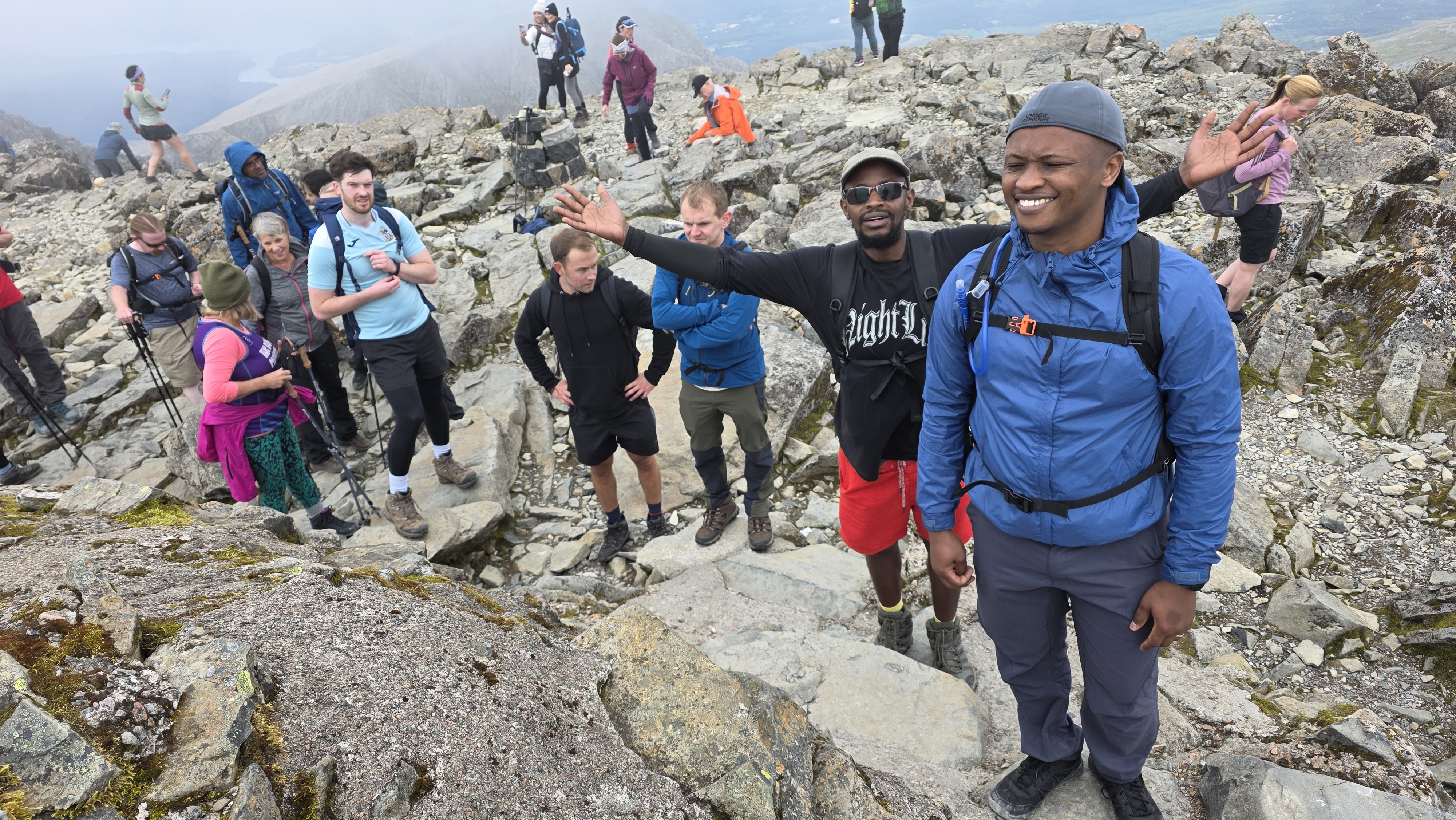 Crowds gather around the summit cairn