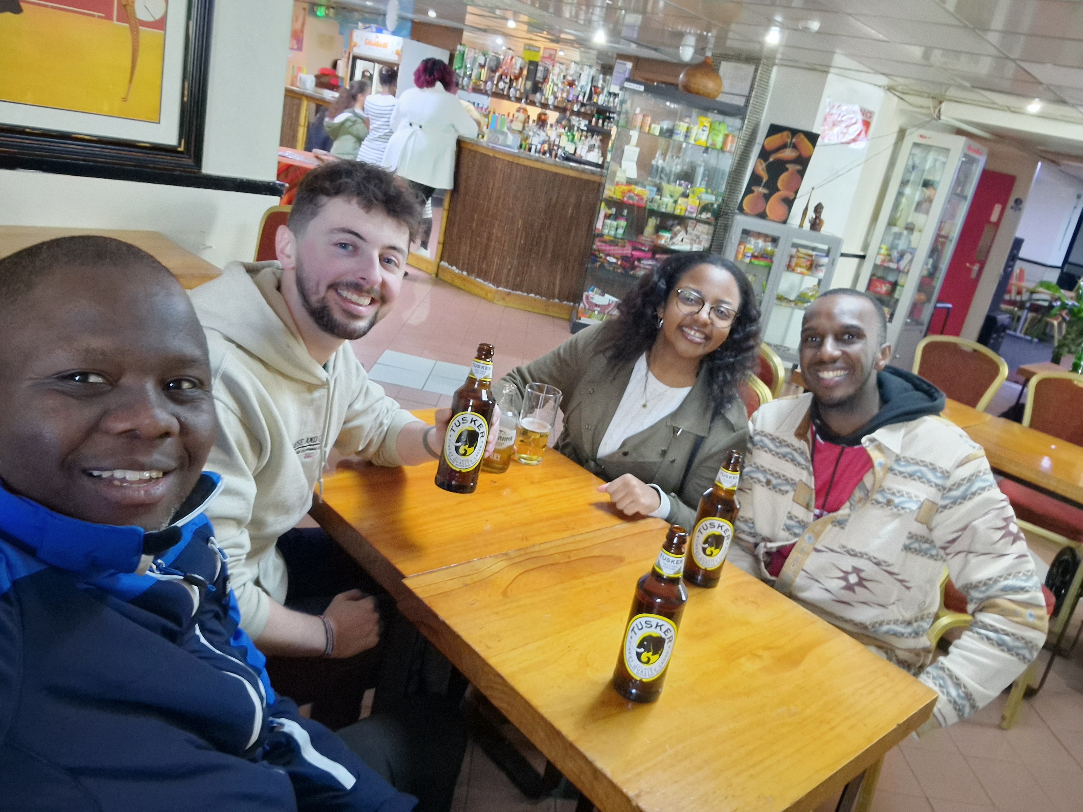 Post-race group celebration over drinks and Tusker